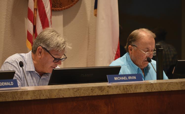 Lampasas EDC Board of Directors Place 7 Michael Irvin and Board President Deorald Finney look on during Wednesday's regular meeting. ERICK MITCHELL | DISPATCH RECORD