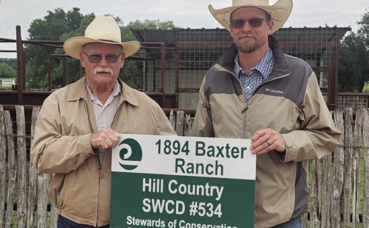 Grady Gibson, left, of Hill Country Soil and Water Conservation District #534, presents Weston McCoury with the Area 5 Conservation Rancher Award for work done on the Baxter Ranch near Bend. COURTESY PHOTO
