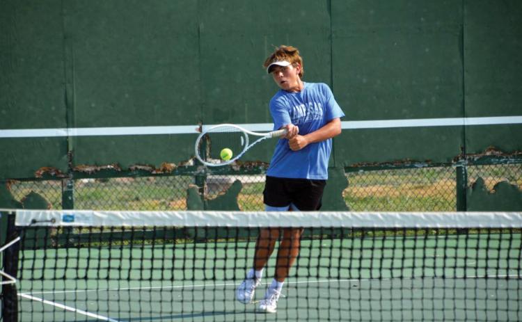 Dylan Skarzynski levels a volley back to his opponent in Tuesday’s singles match versus Weiss. COURTESY PHOTO