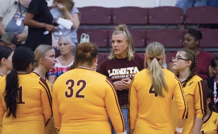 Coach Madison Morris gives a pep talk to her team. The Lady Hornets are looking for their first district win. ANA SOFIA MEYER | DISPATCH RECORD