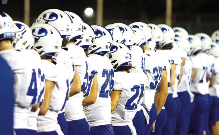HUNTER KING | DISPATCH RECORD The Badger football team stands on the sideline prior to the start of their area-round playoff game against Alice.