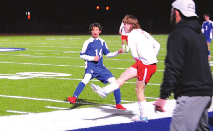 Tyler Ecker puts a foot into a challenge against Salado on Friday night. Head coach Samuel Burnside looks on. HUNTER KING | DISPATCH RECORD