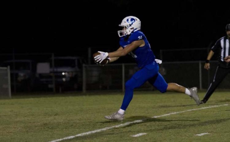 Ethan Moreno reaches for the goal line for one of his four touchdowns of the night during the Badgers’ rout of Elgin on Friday. HUNTER KING | DISPATCH RECORD
