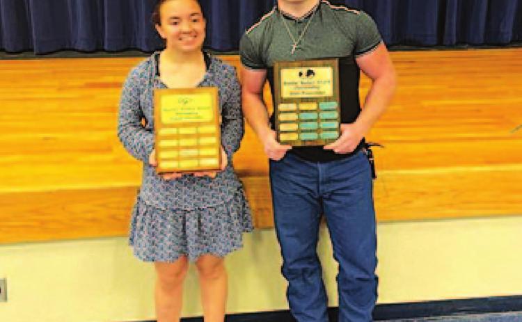 Brianna Miller, left, and Westen Reid pose with their Battlin’ Badger trophies at the powerlifting banquet. COURTESY PHOTO