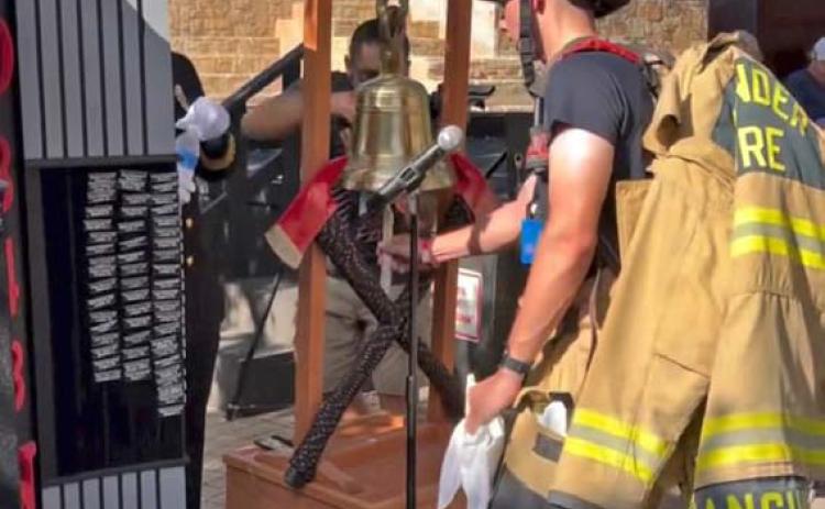 courtesy photo Hunter Sanguinet, a firefighter for the communities of Leander and Lampasas, rings the ceremonial bell upon completing the San Antonio 110. The bell toll memorializes a fallen first responder.