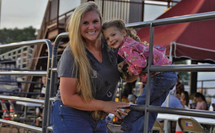 Friday’s Riata Roundup Rodeo provided a night of family fun. From left, Kaila and Wren Rogers pose for a photo just outside the 580 Sports Park rodeo arena. ERICK MITCHELL | DISPATCH RECORD