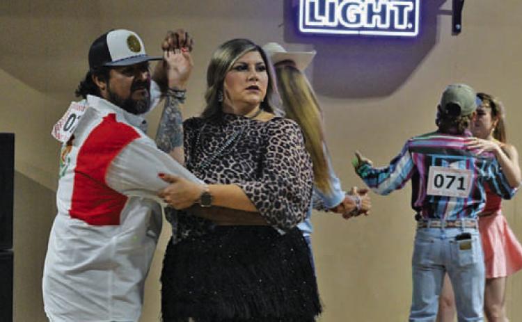 Armondo Rosales helps his dance partner, Karli Rosales, make their way around the dance floor. ERICK MITCHELL | DISPATCH RECORD