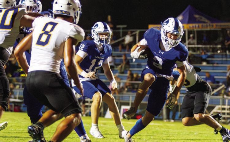 Lampasas senior Jonathan Bowling, a two-way player at defensive back and running back, breaks a tackle to sneak into the end zone for his second touchdown of the night against Lago Vista. ANA SOFIA MEYER | DISPATCH RECORD