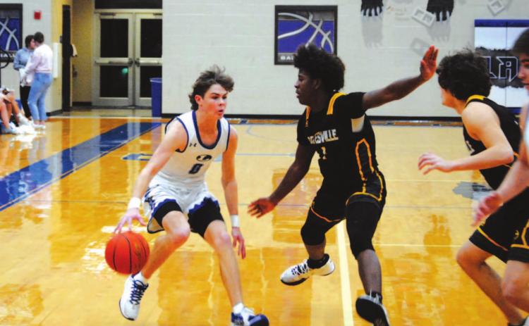 Nate Borchardt dribbles and looks for a way past two Gatesville defenders in a game last week. HUNTER KING | DISPATCH RECORD