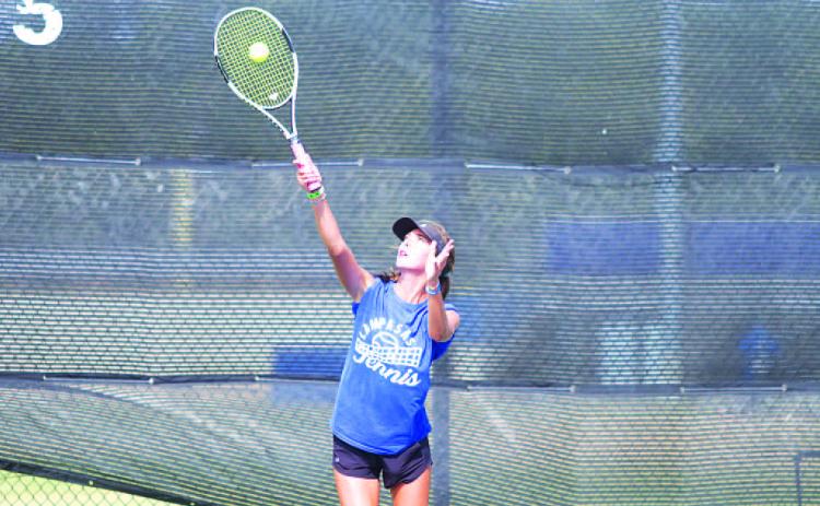 Chesley Breuer makes contact on a serve during a match last week. HUNTER KING | DISPATCH RECORD