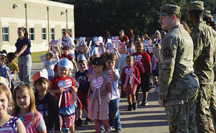Students at Taylor Creek Elementary show their love for country and patriotic colors at a commemorative parade and assembly last Thursday morning. For more on the event that recognized the 24th anniversary of the 9/11 attacks on the nation, see page 2. ERICK MITCHELL | DISPATCH RECORD