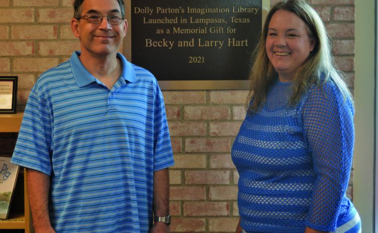 Tyler Byrd and his sister Elizabeth Byrd pose for a photo with the plaque honoring their late parents, Becky and Larry Hart. A donation from Elizabeth in honor of her parents helped launch the Dolly Parton’s Imagination Library program in Lampasas in 2021. ERICK MITCHELL | DISPATCH RECORD