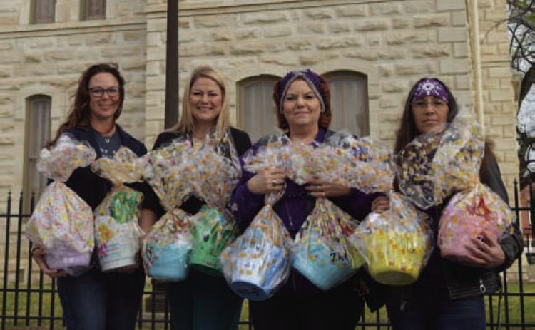 Shown left to right: Lampasas CPS Board President Colleen Eckermann and Board Treasurer Crystal Banks receive Easter egg baskets from Silverbacks Motorcycle Club members Diane Trujillo and Angelicca Conner. The baskets will go to children in CPS care. ERICK MITCHELL | DISPATCH RECORD