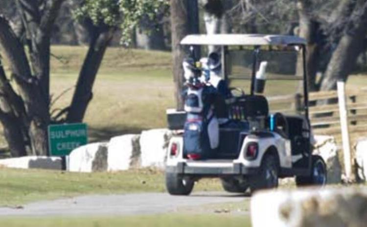 Golf cart drivers at Hancock Park Golf Course prepare to cross Naruna Road. A city ordinance stipulates that licensed drivers may operate golf carts on public roadways only to travel to and from cemeteries and the golf course. JEFF LOWE | DISPATCH RECORD