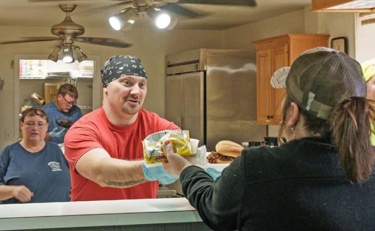 Adam barrios | DISPATCH RECORD Kempner Volunteer Fire Department member Steve Martin serves a lunch plate during the department’s annual BBQ Fundraiser and Auction on Saturday.
