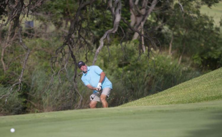 Scott Haverly hits a chip shot onto the green on his way to a third place finish in the Championship Flight of the Britches and Bows tournament on Saturday and Sunday at Hancock Park Golf Course in Lampasas. HUNTER KING | DISPATCH RECORD