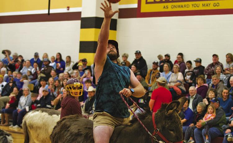 HUNTER KING | LAMPASAS DISPATCH RECORD Sam Pauly tosses the ball toward the hoop during Saturday night’s Donkey Basketball game.