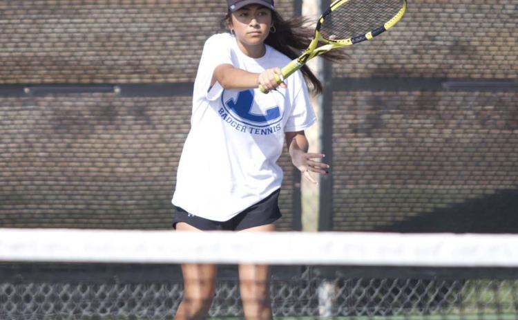 Junior Amore Zapata follows through on a forehand return during a doubles match against Leander last week. She and Alyssa Sharkey won their most recent match in straight sets. HUNTER KING | DISPATCH RECORD