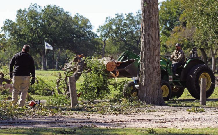 Hancock Park Golf Association members offered assistance Tuesday morning to clear debris from the golf course after high winds Monday night damaged trees and left the municipal course unplayable temporarily. JOYCESARAH MCCABE | DISPATCH RECORD