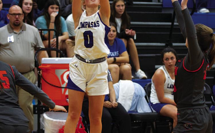 Addison Borchardt shoots a three-point shot over a defender. HUNTER KING | DISPATCH RECORD