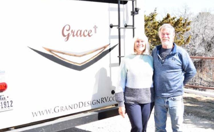 Tim and Kathy McPherson pose by their fifth-wheel RV that they have named “Grace.” ALEXANDRIA RANDOLPH | DISPATCH RECORD