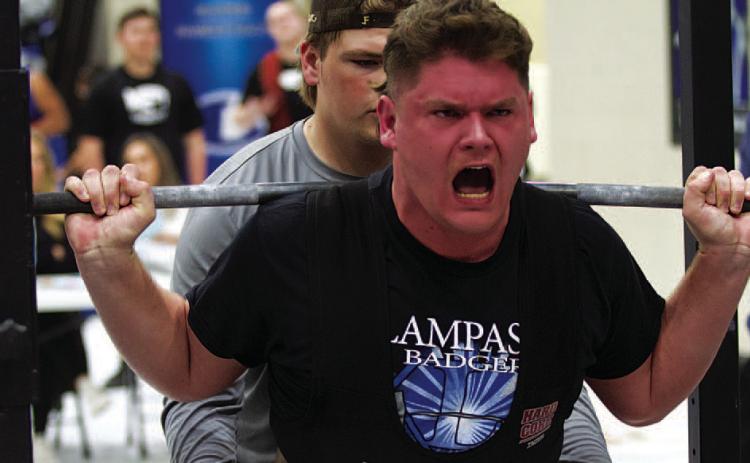 Deegan Norwood strains to lift during the squat portion of last week’s powerlifting meet. HUNTER KING | DISPATCH RECORD