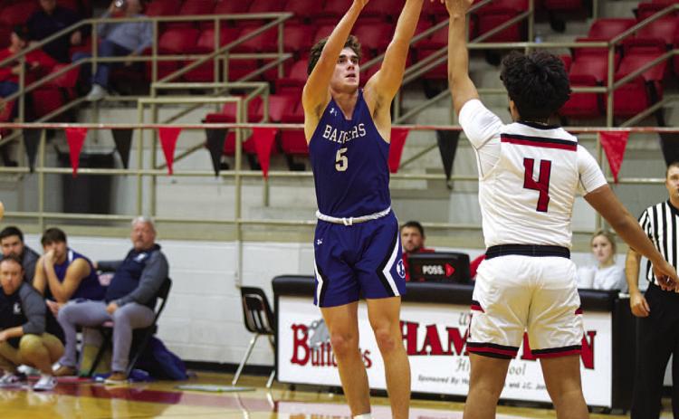 Trent Seneca shoots a three-point shot over a defender. HUNTER KING | DISPATCH RECORD