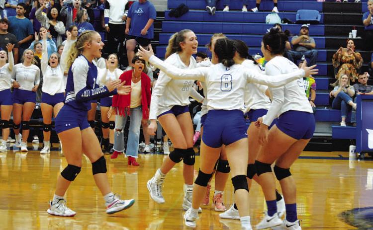 HUNTER KING | DISPATCH RECORD The Lady Badgers celebrate after a point in the third set against Gatesville on Tuesday.