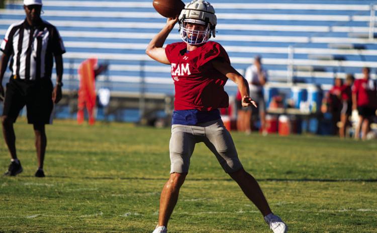 HUNTER KING | DISPATCH RECORD JT Posten rolls to his right and throws into the flat during last Friday’s scrimmage.