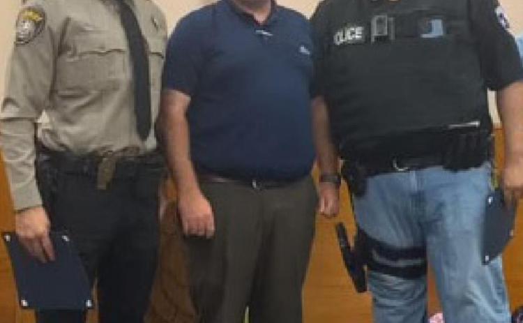 Kempner Mayor John Wilkerson, center, honors Lampasas County Sheriff’s Office Deputy Raymond Barrera, left, and Interim Chief of Police Heriberto “Eddie” Rodriguez during the Kempner City Council’s meeting July 27. CITY OF KEMPNER FACEBOOK
