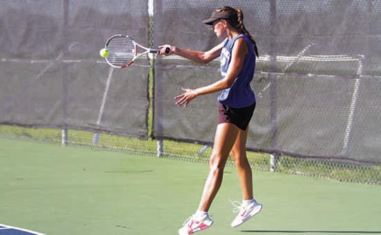 HUNTER KING | DISPATCH RECORD Chesley Breuer hits a forehand shot during her singles match.