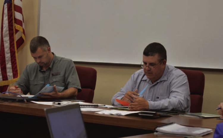 At left, Lampasas Central Appraisal District Board Chairman Marshal Brewer and Board Member Chris Harrison review the 2025 proposed budget amendments during Thursday’s meeting. ERICK MITCHELL | DISPATCH RECORD
