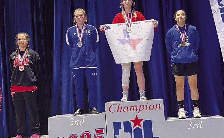 COURTESY PHOTO | DONOVAN KLECKNER Taylor Martell stands on the second-place spot of the podium at the state wrestling meet.