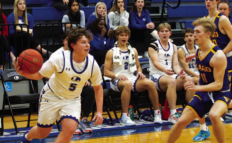 Aidan Nuckles dribbles past a Lago Vista defender. He scored 11 points in Tuesday’s game. HUNTER KING | DISPATCH RECORD