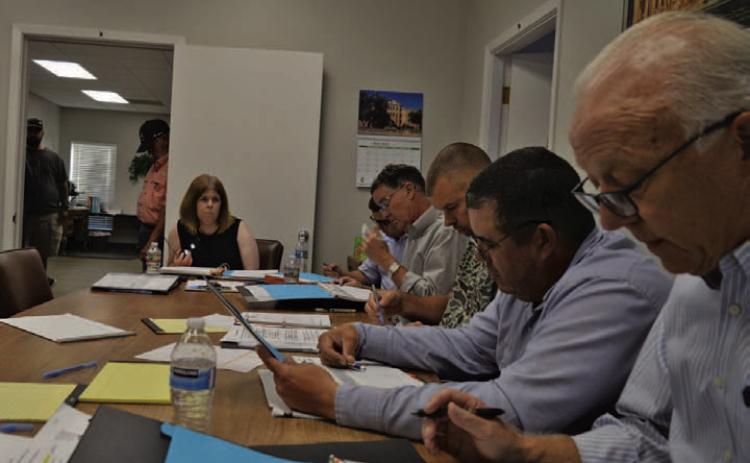 At back, Lampasas Central Appraisal District Chief Appraiser Susan Jones discusses budget matters Thursday evening alongside LCAD Board of Directors members. ERICK MITCHELL | DISPATCH RECORD