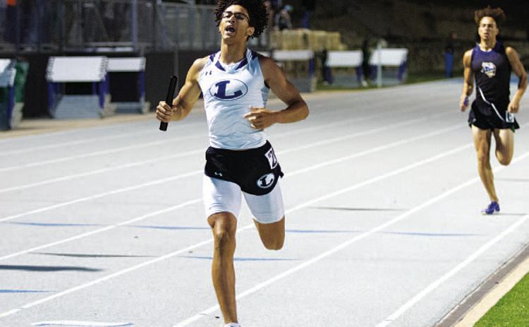 Ty Johnson crosses the finish line to win the 4x400-meter relay at the district track meet last week. HUNTER KING | DISPATCH RECORD