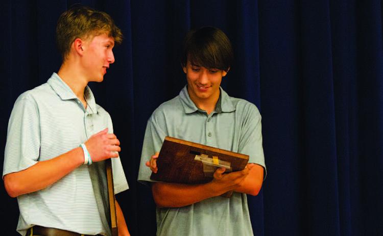 HUNTER KING | DISPATCH RECORD From left, Jonas Andersen and Calvin Phelps check out their team awards at the baseball banquet on Tuesday.