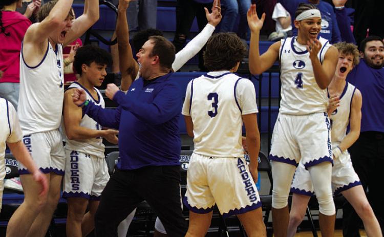 HUNTER KING | DISPATCH RECORD Head coach Aaron Nuckles and his team erupt in celebration as the final seconds ticked off the clock.
