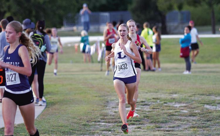 Leah Phillips shows emotion as she approaches the finish line at the district meet. HUNTER KING | DISPATCH RECORD