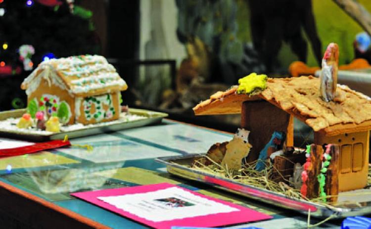 At right, the “Away in a Manger” gingerbread house created by Kylee Davis earned first place in the 8- to 12-year-olds division, while the “Carolers” house to the left made by Gwendolyn Martin earned second. ERICK MITCHELL | DISPATCH RECORD