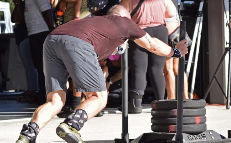 A competitor in a functional fitness competition pushes a sled with a total weight of 187 pounds across a distance in a timed trial. Pushing one’s own limits is the only way to experience significant change, whether that be in fitness, habits and routine, or matters of lifetime accomplishment. alexandria Randolph | dispatch record
