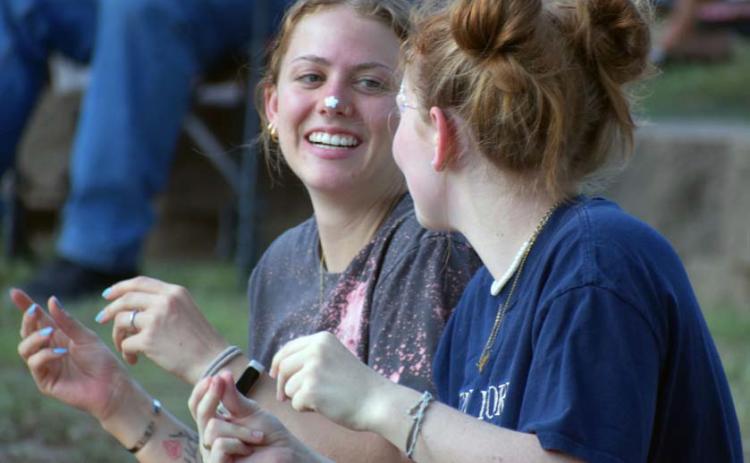 Lydia Skiles and Lyla Skiles snap along to the music at the annual Spring Ho Festival Gospel Night. JOSEPH NEUENSCHWANDER | LAMPASAS