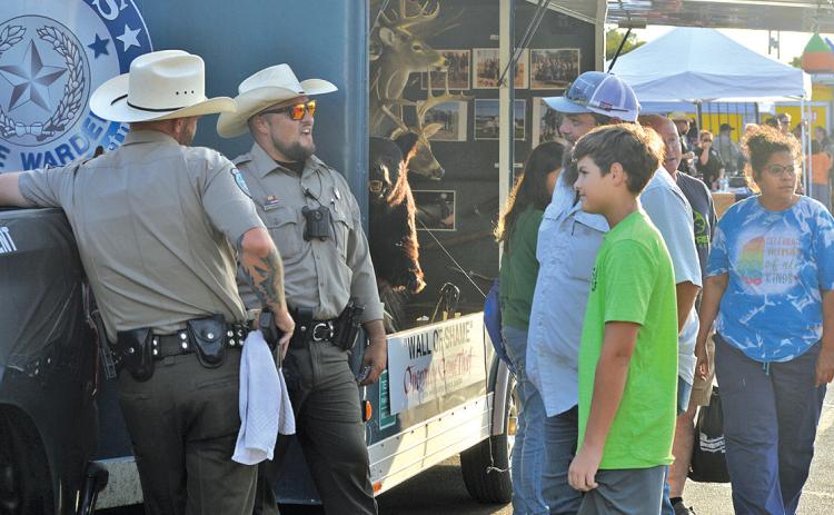 Lampasas residents stop by for a chat at the Texas Game Warden booth at last year’s National Night Out event. file photo
