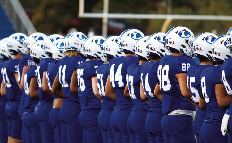 The Badger football team lines up before every game as the coin is tossed to begin each contest. HUNTER KING | DISPATCH RECORD