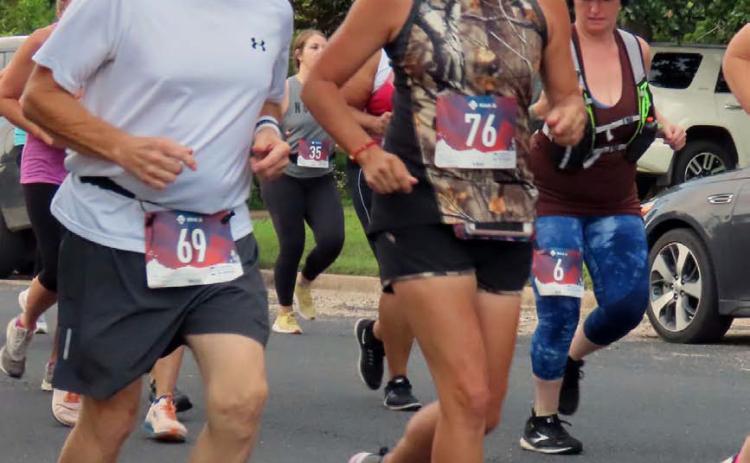 Steve McDaniel, left, runs in the Navidad Valley Cattlewoman’s Ranch Run in Schulenburg. COURTESY PHOTO | KAYE MCDANIEL