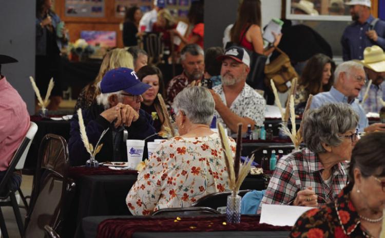 Reverse Raffle attendees enjoy a ribeye steak dinner during last year’s event. A similar meal will be served at this year’s showcase before the live auction gets underway. FILE PHOTO