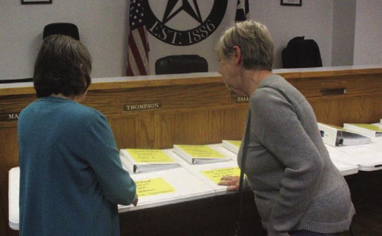 Lometa resident Cynthia Kirby, left, and Lometa City Council member Gloria Martin review the city’s breakdown of accounts on display at Monday night’s council meeting. CHERI JAY-WIENECKE | DISPATCH RECORD