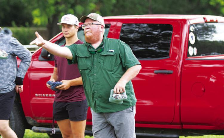 HUNTER KING | DISPATCH RECORD Trampus Isom tosses a bag during the cornhole tournament last Saturday.