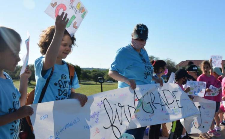 CJ’s classmates and teachers greeted him with signs Thursday morning. MONIQUE BRAND | DISPATCH RECORD