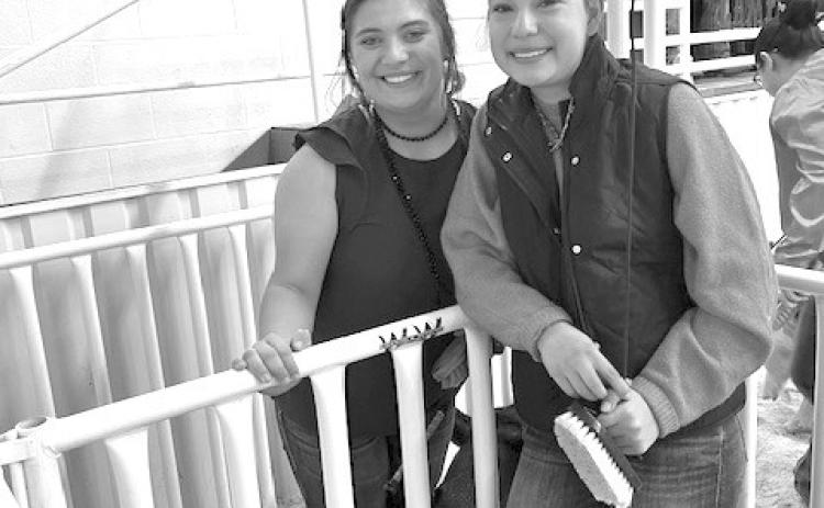 Ava Rojas, at left, stands alongside Emory Vineyard at the Lampasas County Youth Livestock Show in January. Vineyard credits Rojas for helping her improve at competitions. COURTESY PHOTO